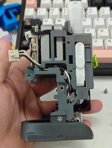Arrange the cables of the fan and Heating Assembly neatly in the cable channels (2)
